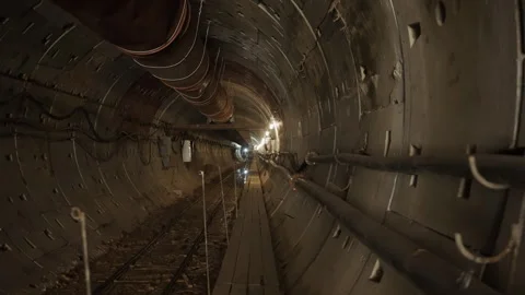 Electrical wiring extends along length of subway tunnel Stockbeeldmateriaal 296714357
