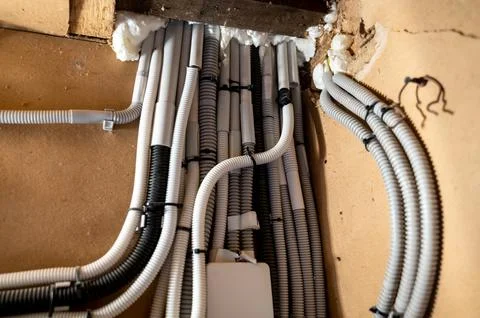 Electrical wiring in private house between floors in plastic conduits Stock Photos