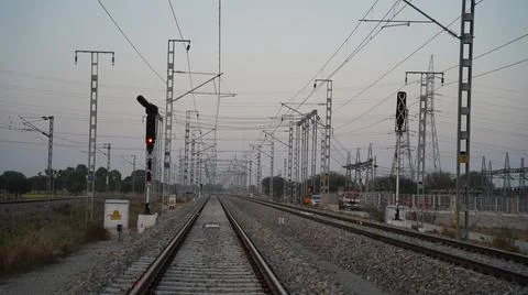 Electrical wiring of the train tracks as it passes through the town. Dense Ra Stock Photos