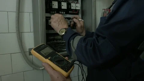 Electrical work near the electric panel Stock Footage 76322497