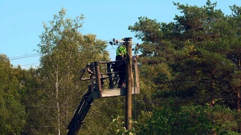 Electrical worker repairs a problem on the power line, part 3 of 3 Stock Footage