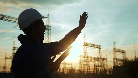 Electrical worker silhouette engineer a working with digital tablet, near tower Stock Footage 138258874