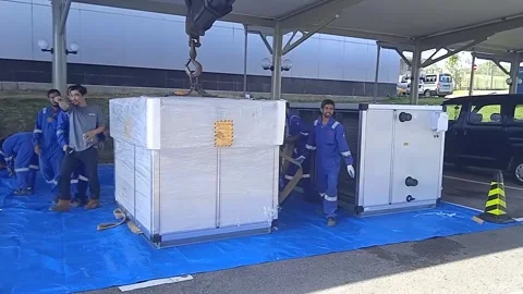 Electrical Workers Lower Two Air Conditioners with a Crane Truck. Stock Footage 304963539