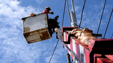 Electrical Workers On Telehandler With Bucket installing High tension wires Stock Footage 86410325