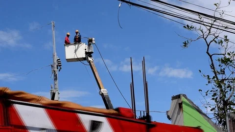 Electrical Workers On Telehandler With Bucket installing High tension wires Stock Footage 86410368