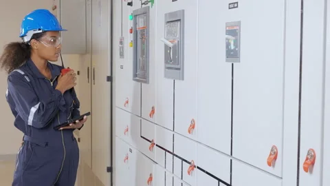 Electrical young asian woman engineer examining maintenance cabinet system el Stock Footage 220736670