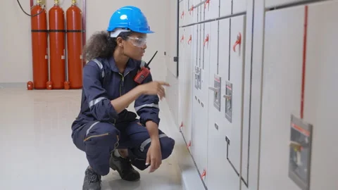 Electrical young woman engineer examining maintenance cabinet system electric Stock Footage 220244504
