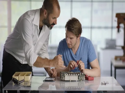 Electrican trainee getting help from his trainer Stock Footage 78571693