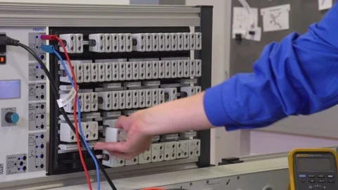 Electrician apprentice working with patch bay and different tools Stock Footage 237316091