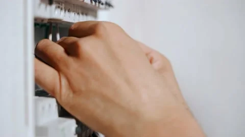 An electrician assembles an electrical panel in an apartment. Manufacture and Stock Footage 148626677