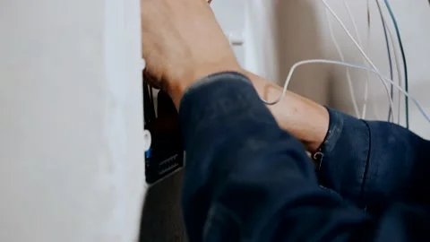 An electrician assembles an electrical panel in an apartment. Electrical box Stock Footage 149125606