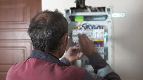 An electrician assembles a switchboard in a new building apartment. Stock Footage 223382182