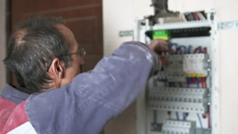 An electrician assembles a switchboard in a new building apartment. Video stock 225499501