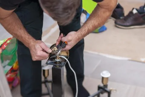 Electrician assembling  chandelier 写真素材