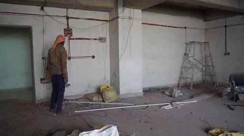 Electrician assembling wire lines and socket powers for new office. Electrici Stock Photos