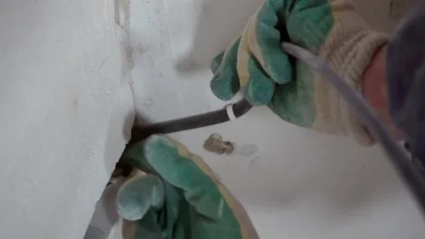 An electrician attaches the wiring to the ceiling. Stock Footage 273348700