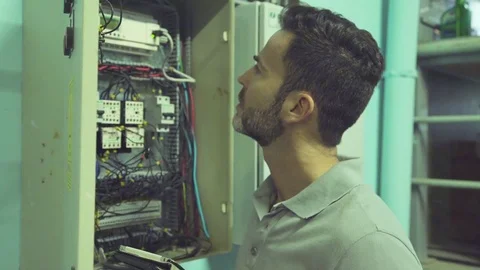 Electrician checking electric control cabinet Stock Footage 75168469