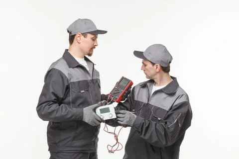 Electrician checking socket voltage with digital multimeter Stock Photos