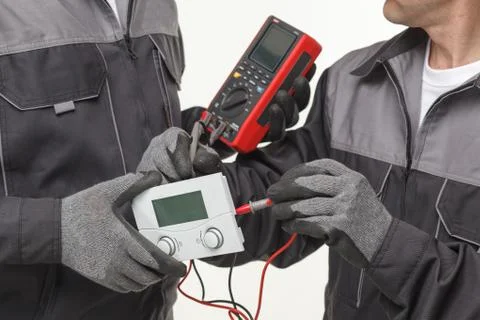 Electrician checking socket voltage with digital multimeter Stock Photos