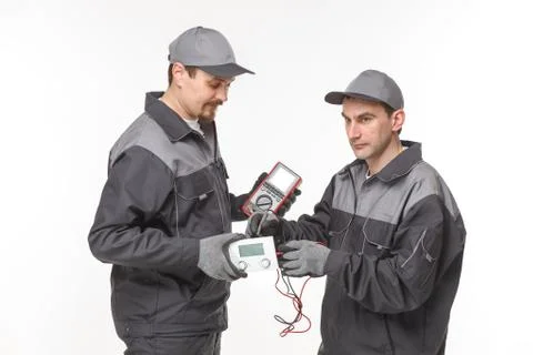 Electrician checking socket voltage with digital multimeter Stock Photos