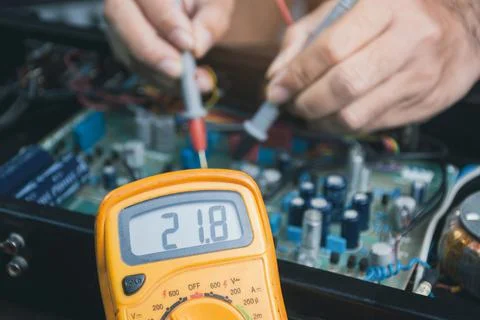 Electrician checking voltage with digital multimeter Stock Photos