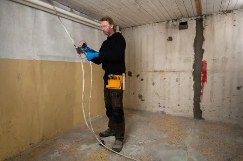 Electrician checking voltage on electrical cables Stock Photos