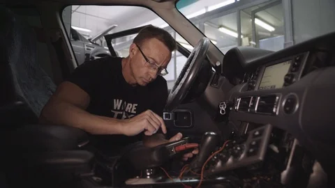 Electrician checks the electronics of the car Stock Footage 94251213
