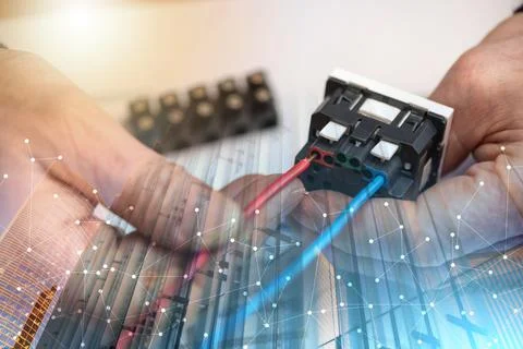 Electrician connecting a wire into a power socket; multiple exposure Stock Photos
