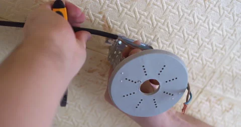 Electrician connecting wires to ceiling light fixture Stock Footage 301087141