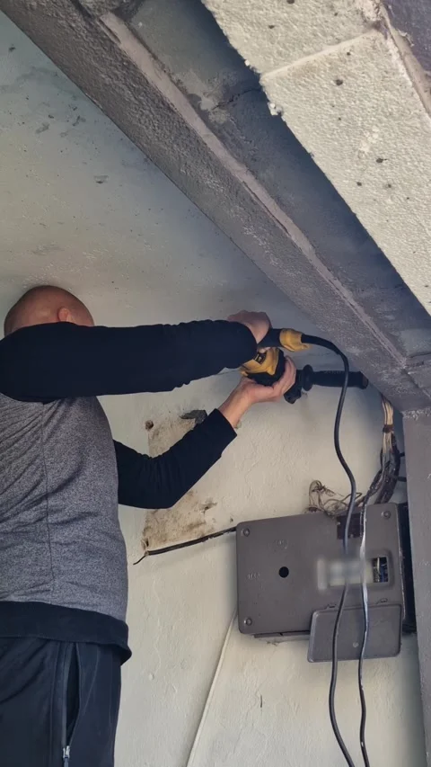 Electrician Connects Wire to Power Meter Box for Repair and Construction Stock Footage 338992225