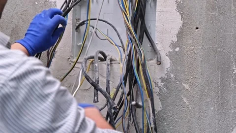 Electrician control panel box home wiring sorting cable install new circuit Stock Footage 265059091