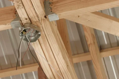 Electrician cutting wires while wiring a ceiling outlet box Stock Footage