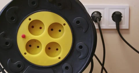 Electrician demonstrates extension socket with cable hank closeup Stock Footage 258504767