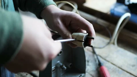 Electrician disassemble an old electrical plug Stock Footage 163645447