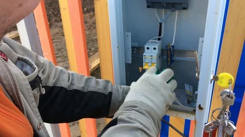 Electrician disconnects electrical shield from electrical wire Stock Footage 75336163