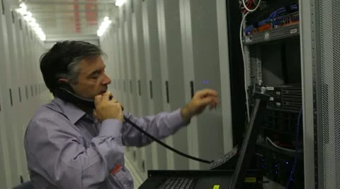 Electrician doing maintenance while phoning Stock-Footage 12290903