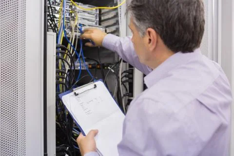 Electrician doing server  maintenance with clipboard Stock Photos