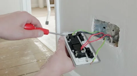 Electrician: earthing a UK plug wall socket Stock Footage 45196042