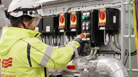 Electrician electric guy man in working reflective vest checking cable Video stock 156554828