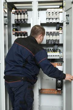 Electrician engineer work tester measuring voltage and current of power elect Stock Photos