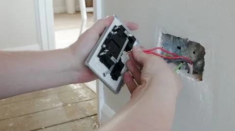 Electrician: fitting the live wire to a UK plug wall socket Stock Footage 45194507