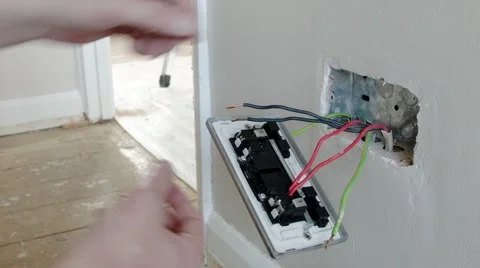 Electrician: fitting the neutral wire to a UK plug wall socket Stock Footage 45195062
