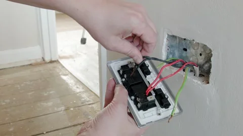 Electrician: fitting the neutral wire to a UK plug wall socket Stock Footage 45195650