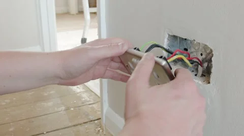 Electrician: fitting a UK plug wall socket Stock Footage 45196208