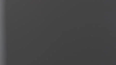 Electrician in gray working clothes fixing light in the office corridor. Dolly Vidéo 67206902