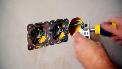 Electrician hands install electrical wall sockets Stock Footage 71167573