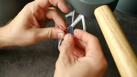 Electrician hands twisting copper wires of chandelier Stock Footage 321739699