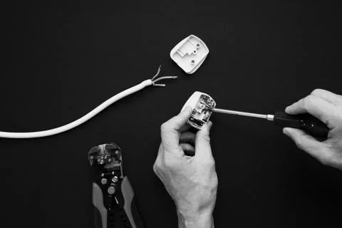 Electrician has plug open Stock Photos