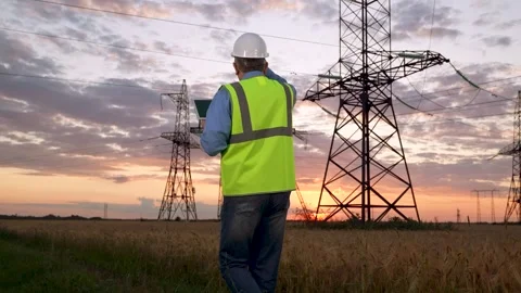Electrician in helmet uses tablet checking equipment of power transmission lines Stock Footage 269836755
