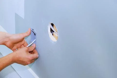 An electrician installed a new current socket during renovation of in apartment Stock Photos